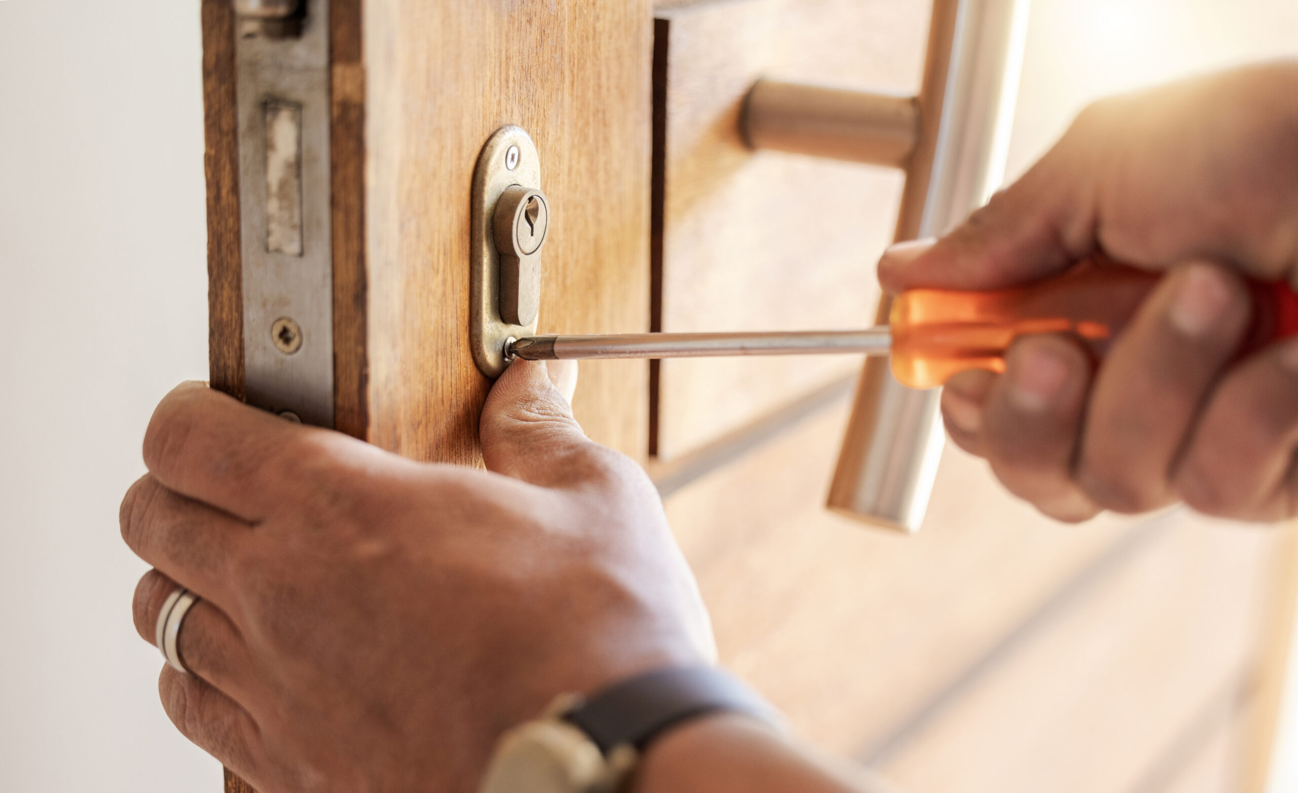Locksmith hands, maintenance and handyman with tools, home renovation and fixing, change door locks.